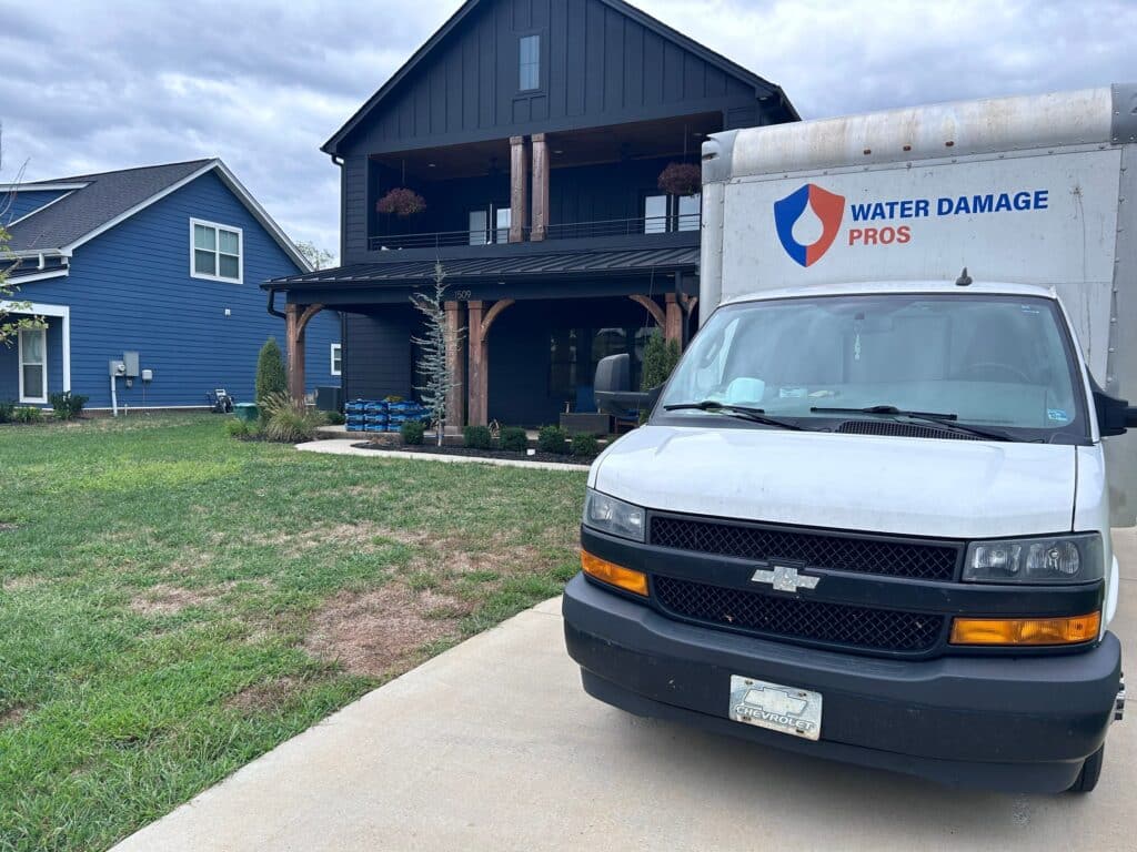 Water Damage Pros Service Truck Parked in Front of a Modern Home – Ready for Emergency Restoration
