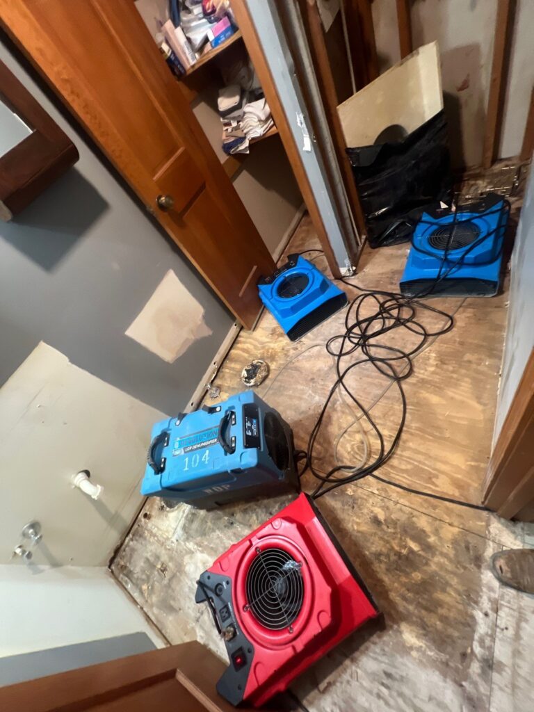 Water damage drying setup in a Nashville home with dehumidifier and air movers during restoration