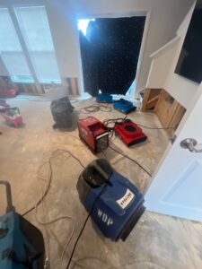Hardwood floor water damage drying in Clarksville, TN, air movers and drying equipment set up to remove moisture