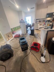 Water damage cleanup after a burst pipe in Clarksville, TN, drying equipment and air movers set up in a kitchen area