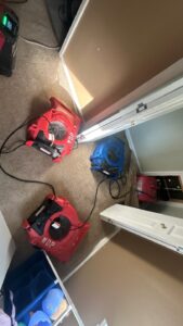 Air movers drying carpet after water damage in a Nashville, TN home