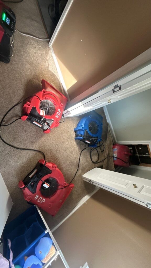 Air movers drying carpet after water damage in a Nashville, TN home