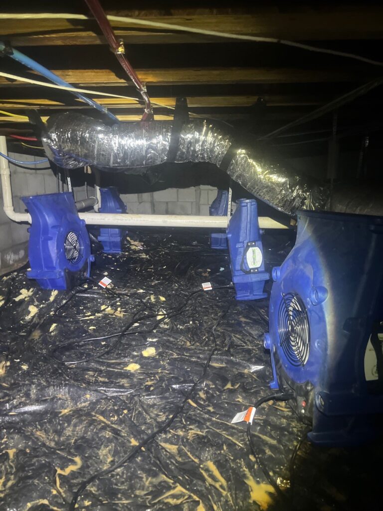 Crawl space drying air movers set up after flooding and moisture damage
